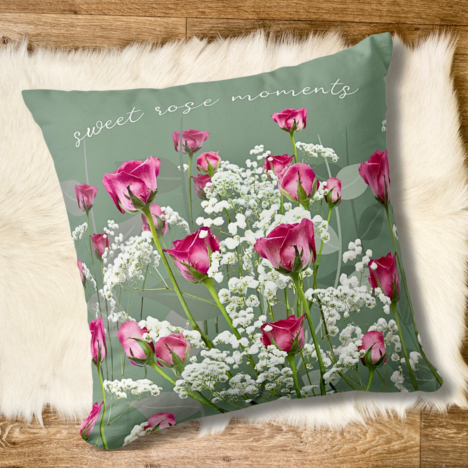 Green throw pillow on a soft rug with pink roses and white flowers, and “sweet pink moments” inspirational quote.