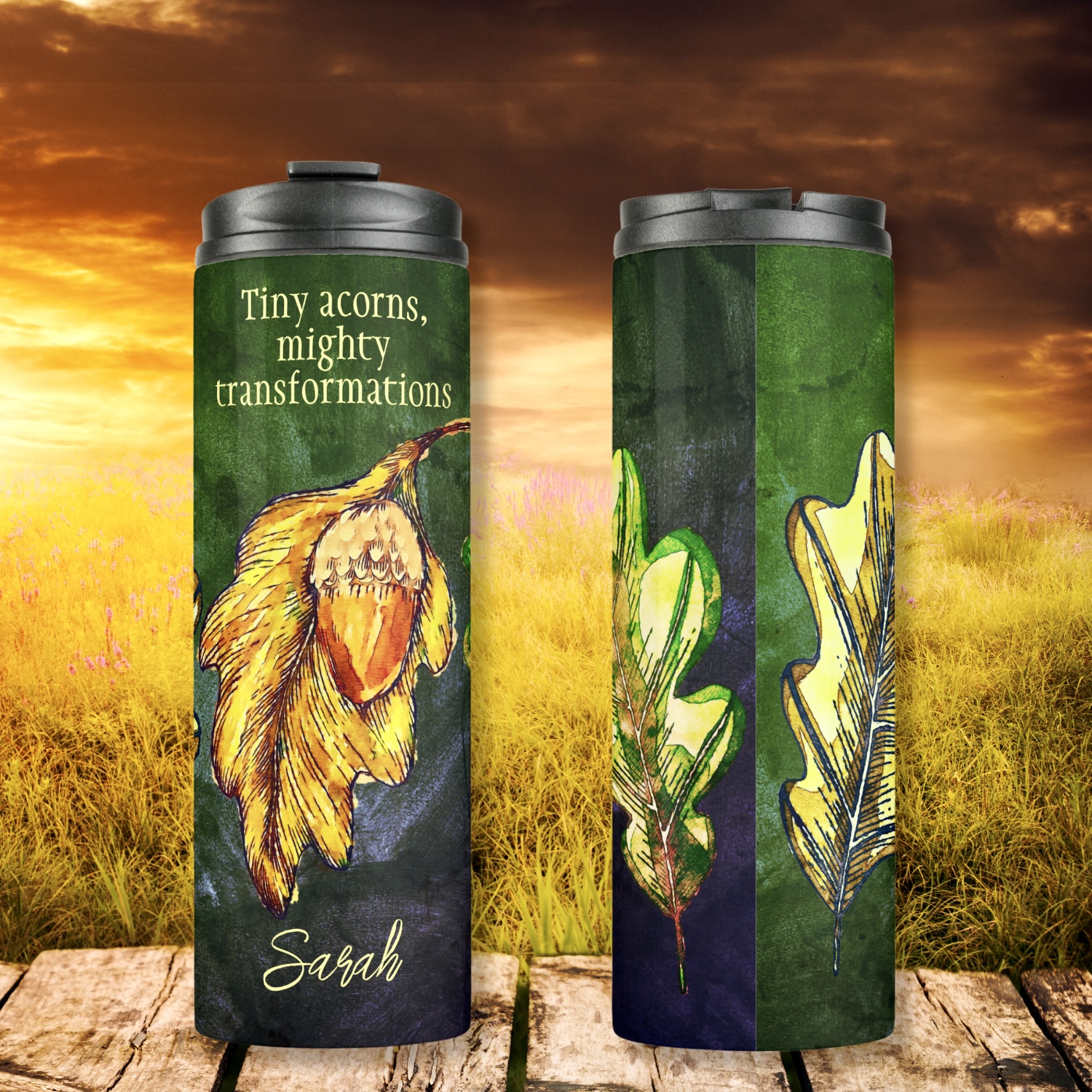 Acorn Fall Colors Inspirational Thermal Tumbler: A bold design featuring lime and golden dry leaves, brilliantly painted golden and orange acorns, arranged in a collage on a dark hunter green washed-out surface. Customizable quote: "Tiny acorns, mighty transformations" or personalize with your own quote or name. Two custom fields for personalization.