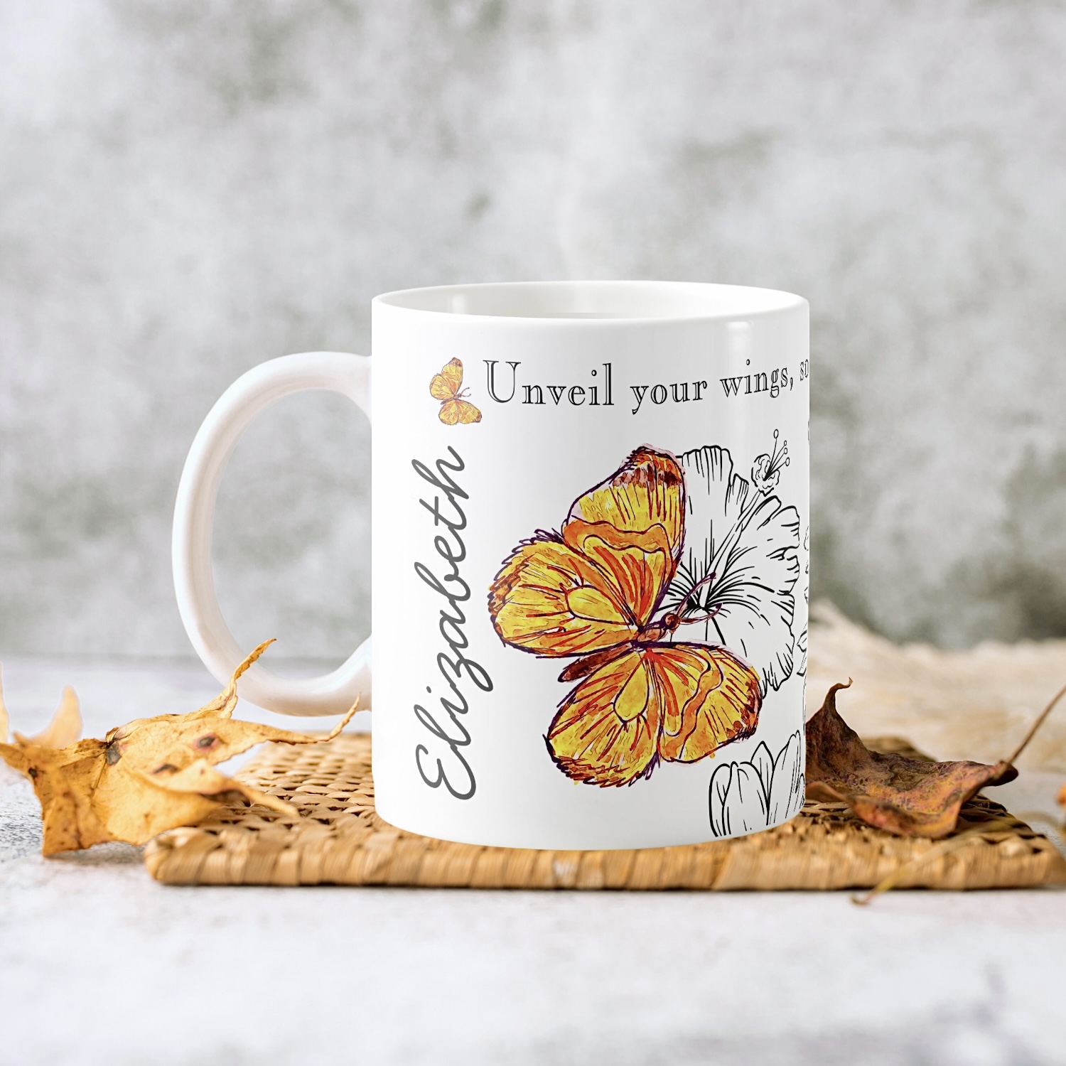 White mug with an orange butterfly drawing.