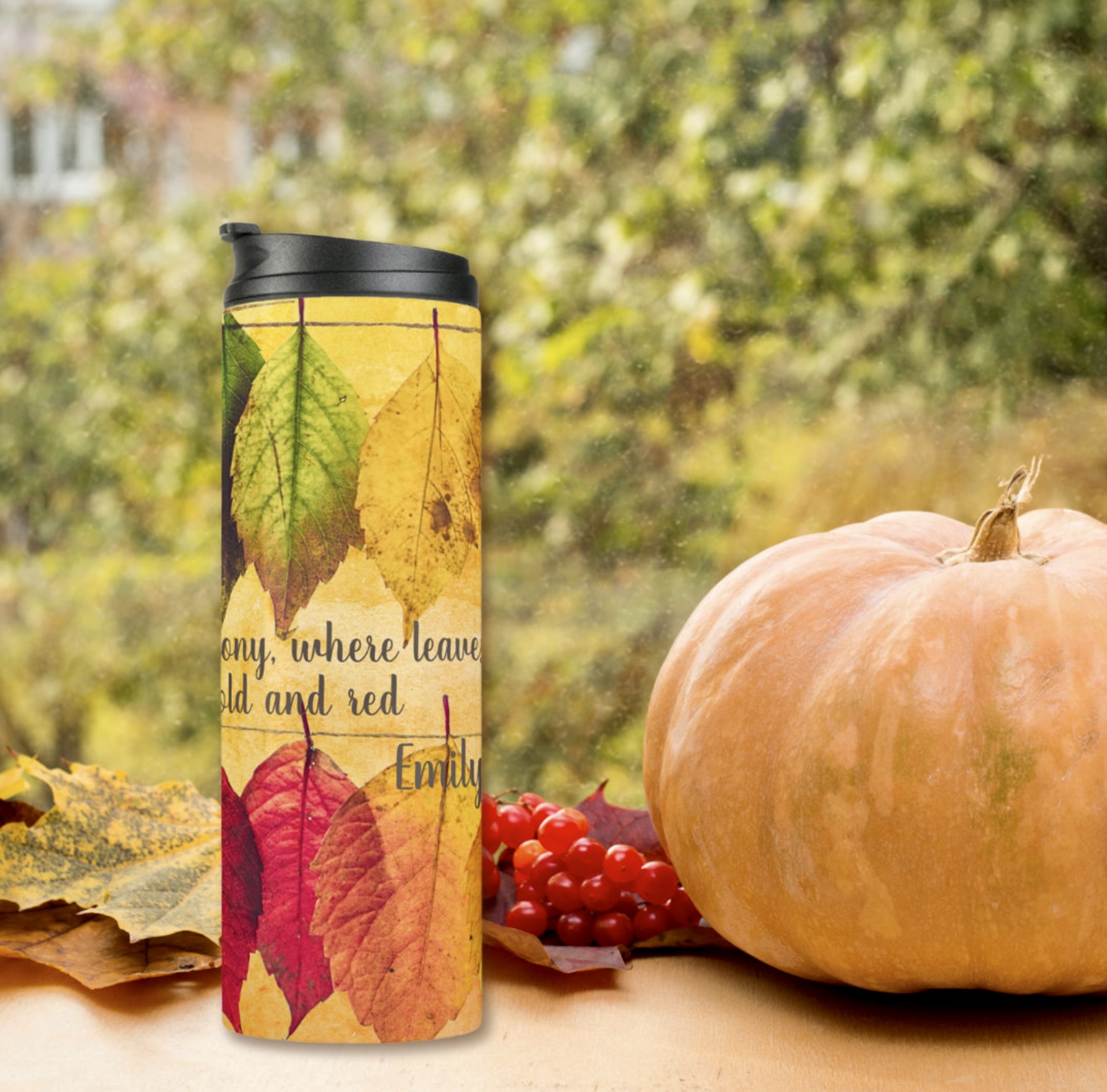 Fall season leafs yellow thermal tumbler and a pumpkin on the side.