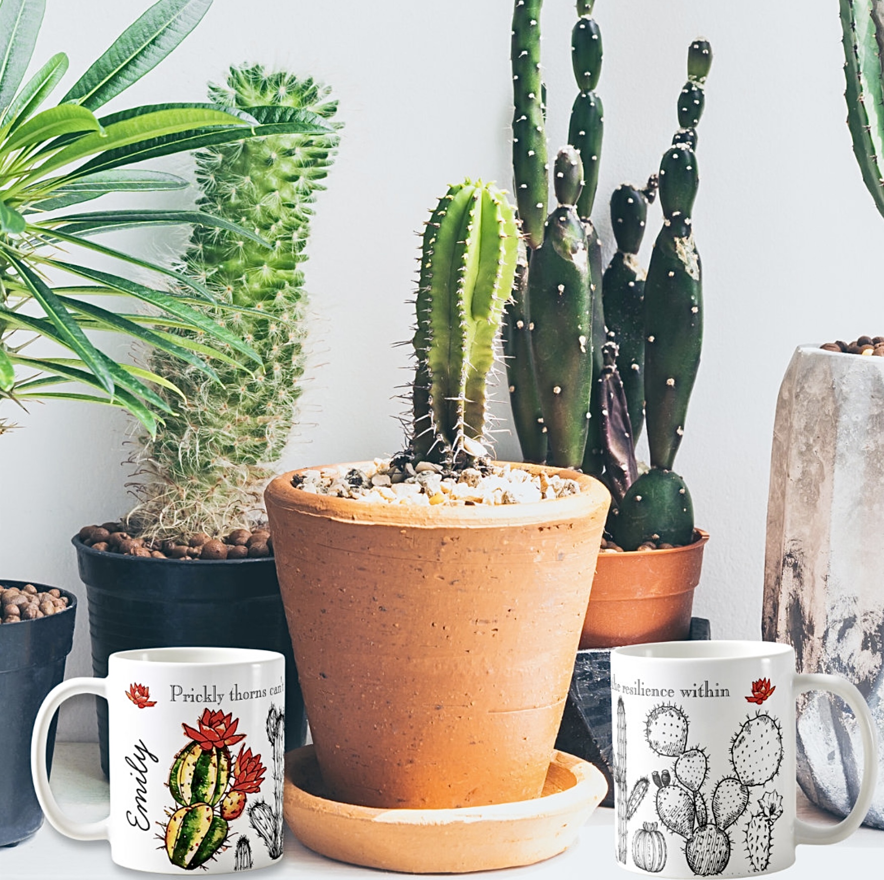 Two white mugs with green cactus images. 