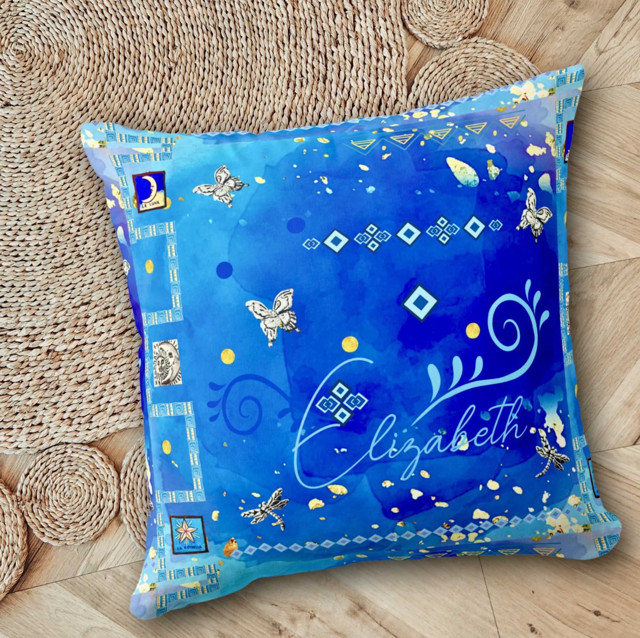 Blue throw pillow with Mexican art motifs in light blue and silver tones, with space for name personalization.