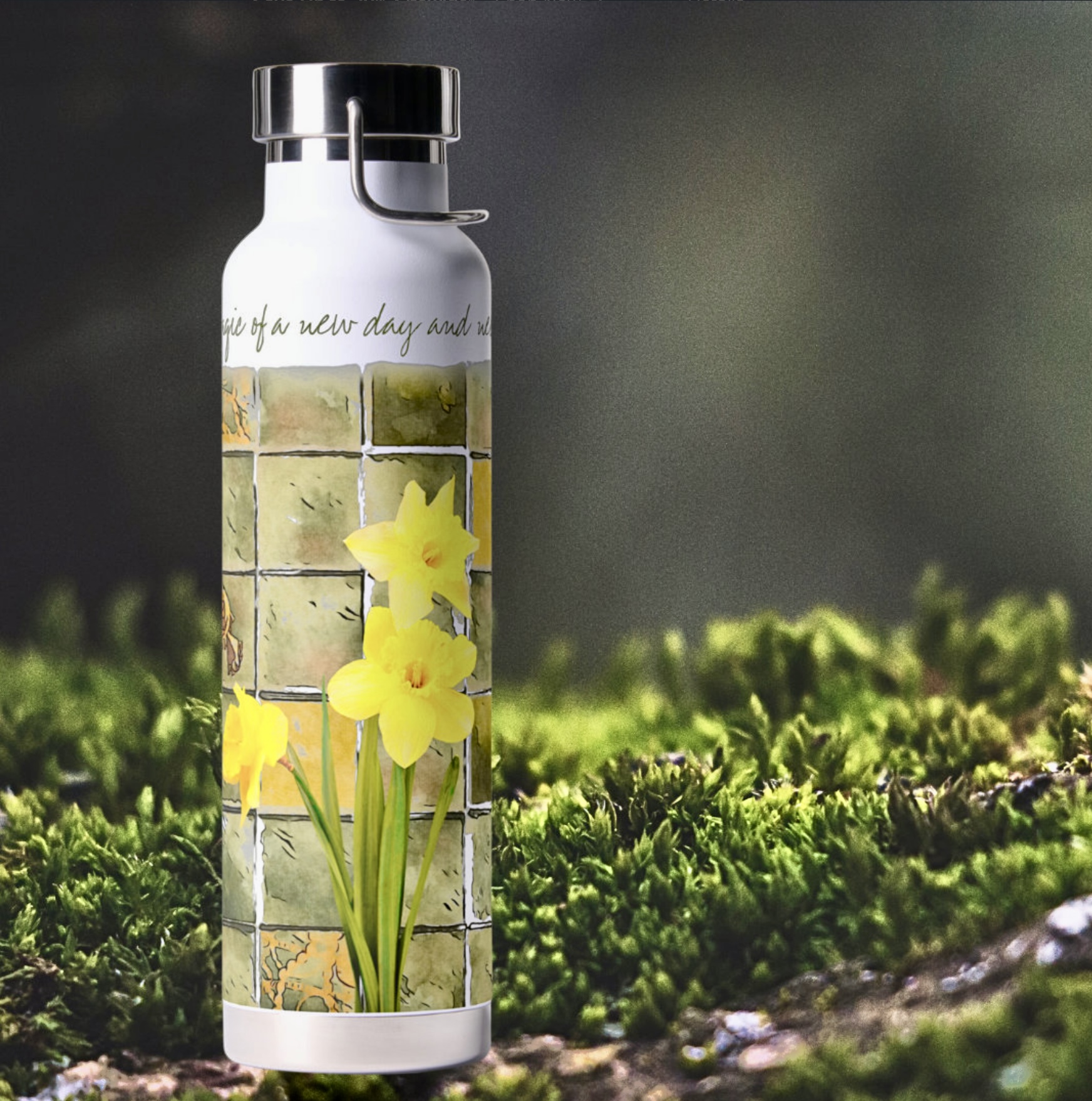 White water bottle with a watercolor illustration with daffodils on a washed out surface in soft yellow and green colors, and inspirational message that says Unveil the magic of a new day and new beginnings.