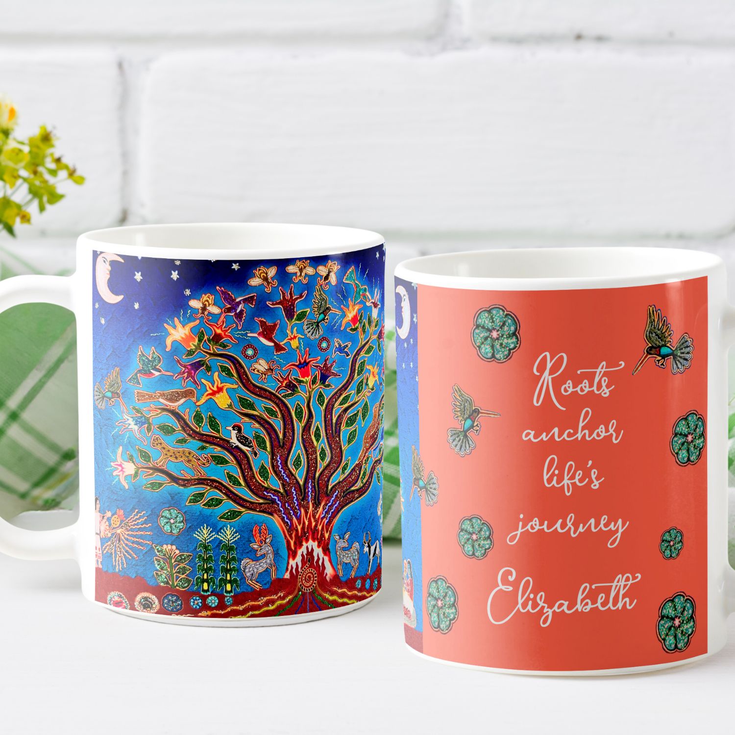 Two coffee mugs. They show the two sides of a coffee mug. One side with a nature design against a night blue sky, and the other side with an inspirational quote on a vibrant peach background.