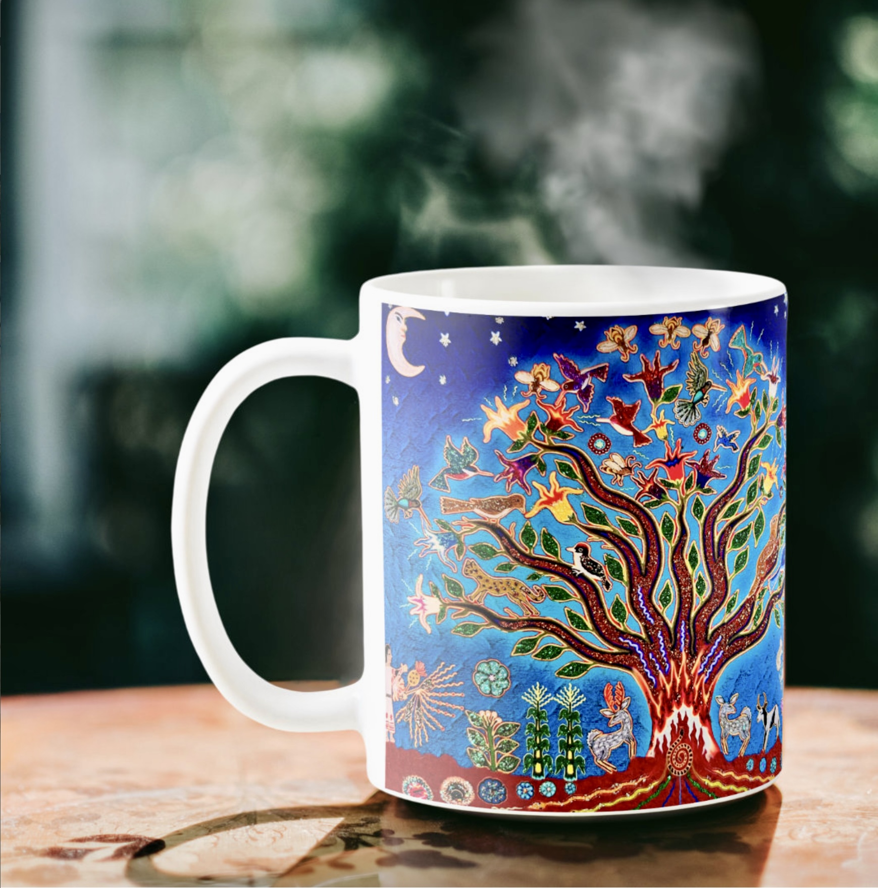 White coffee mug with the illustration of a colorful tree of life against a night sky. 