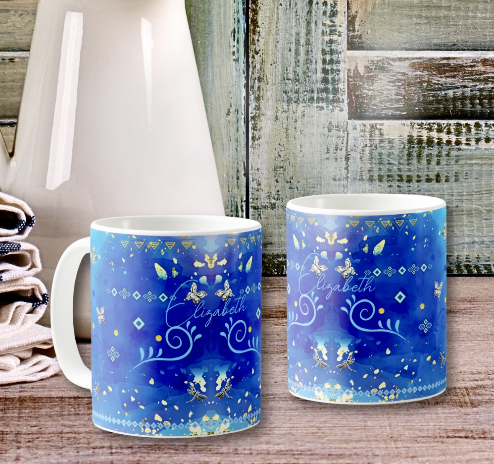 Two blue mugs with indigenous motifs from Mexico in silver and light blue colors. Boho eclectic design.