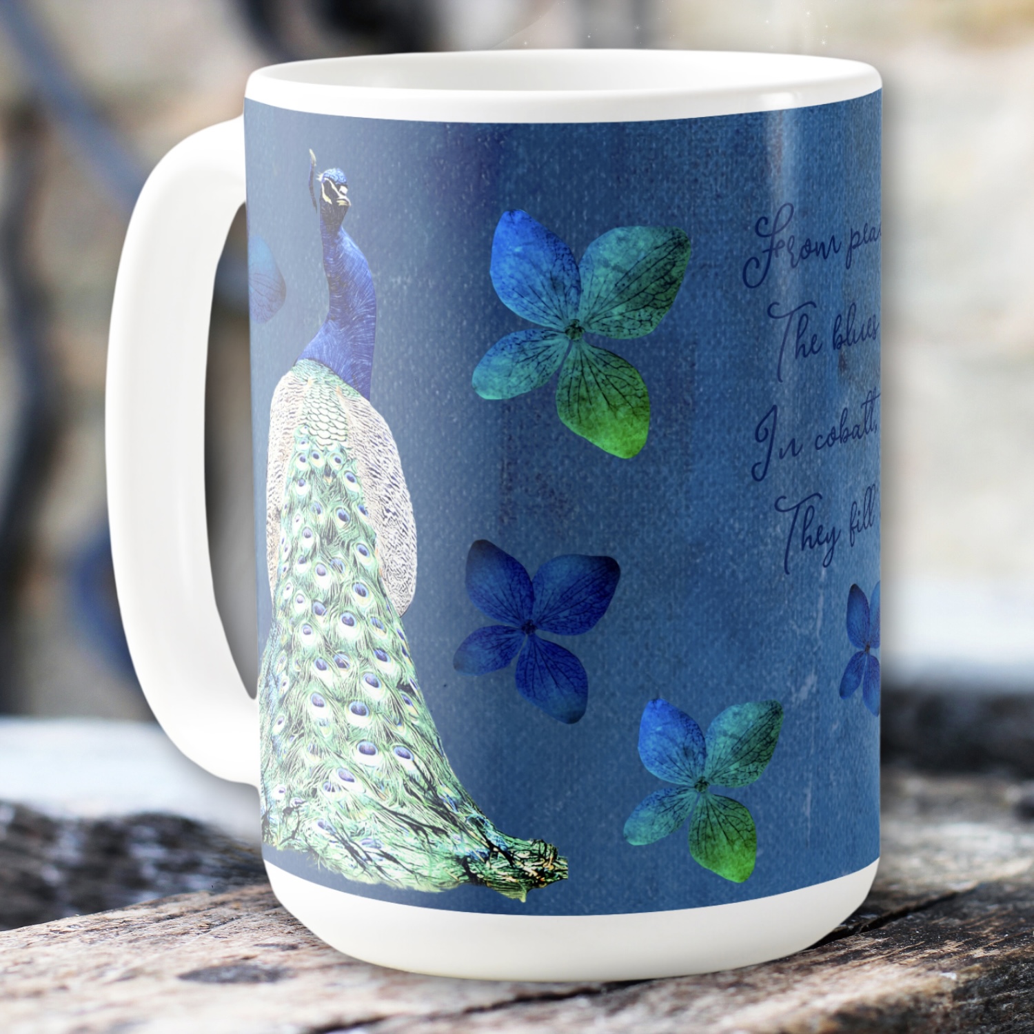 Side view of a cobalt blue mug with a blue peacock and green blue flowers. Nostalgic and romantic design.