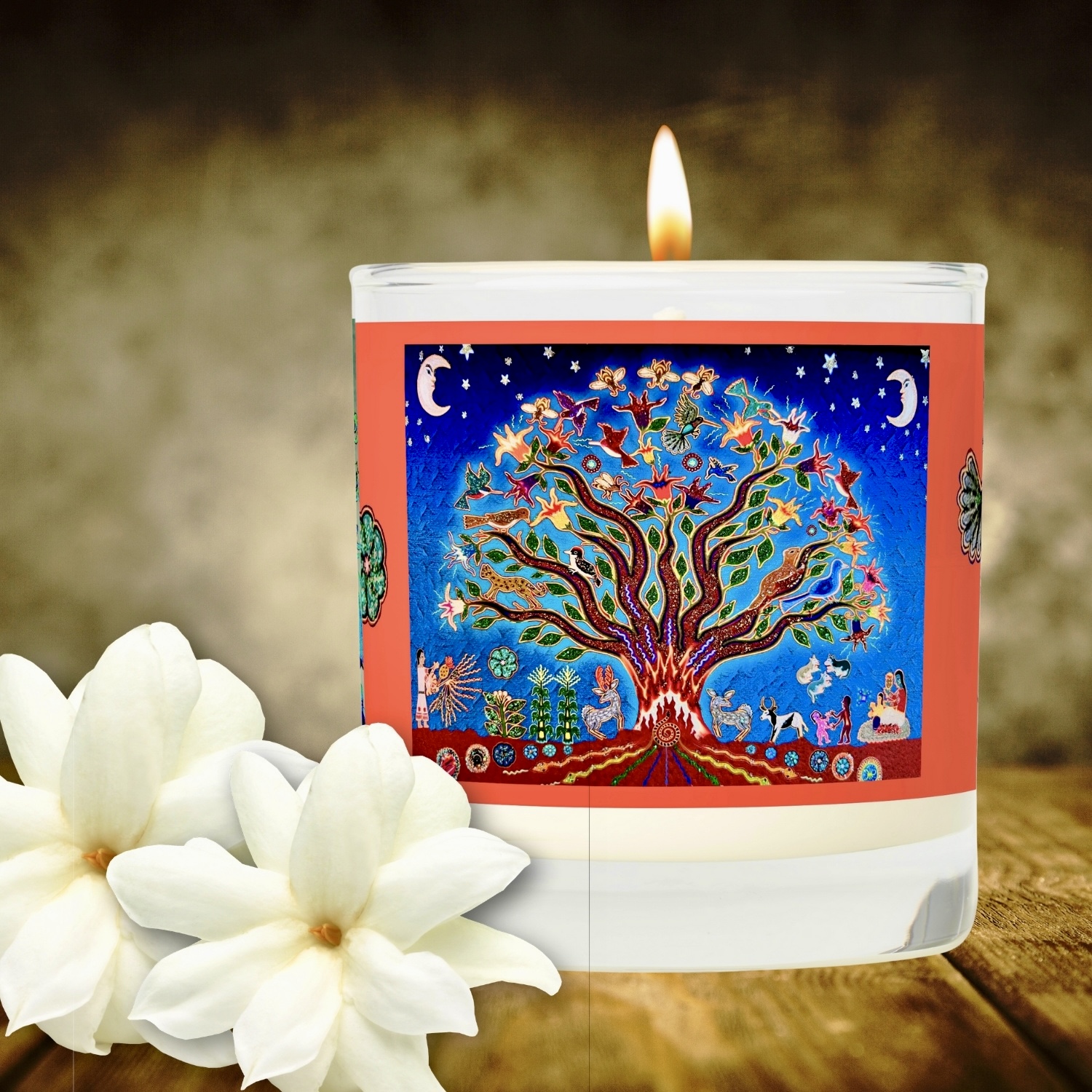 A scented candle in a glass jar, featuring the Night Sky Tree of Life design on its label. The candle emits a warm, inviting glow, adding a touch of ambiance to any space. The label showcases a vivid depiction of a majestic tree with swirling branches against a dark blue background dotted with stars, evoking a sense of tranquility and enchantment.