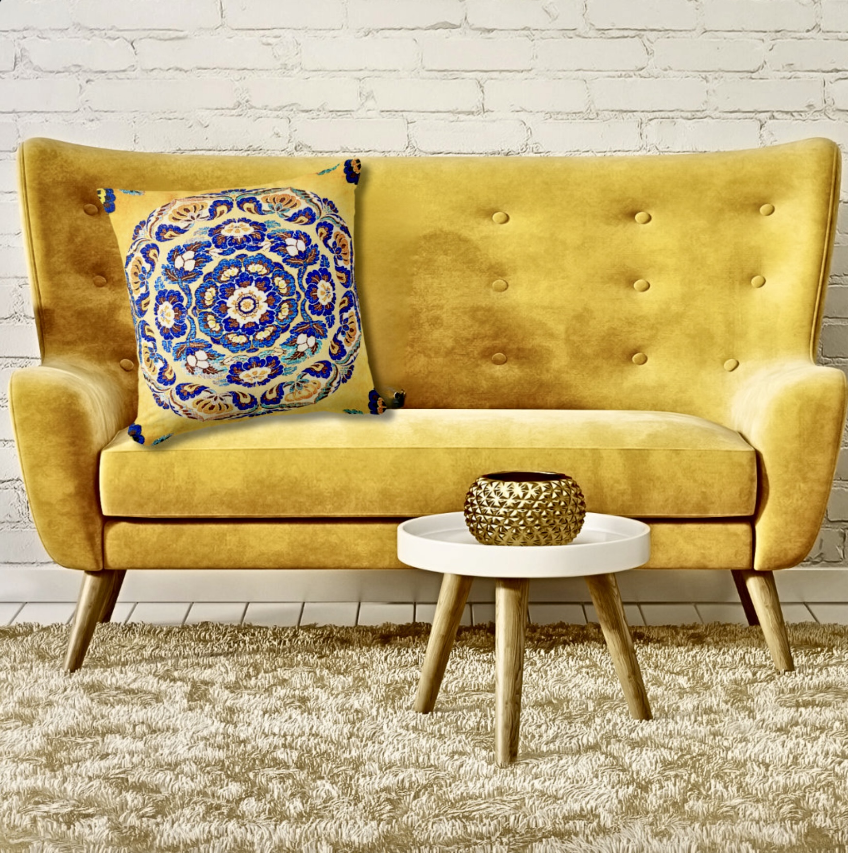 Blue flower medallion pillow on a washed out mustard surface, leaning on a classic yellow sofa chair.