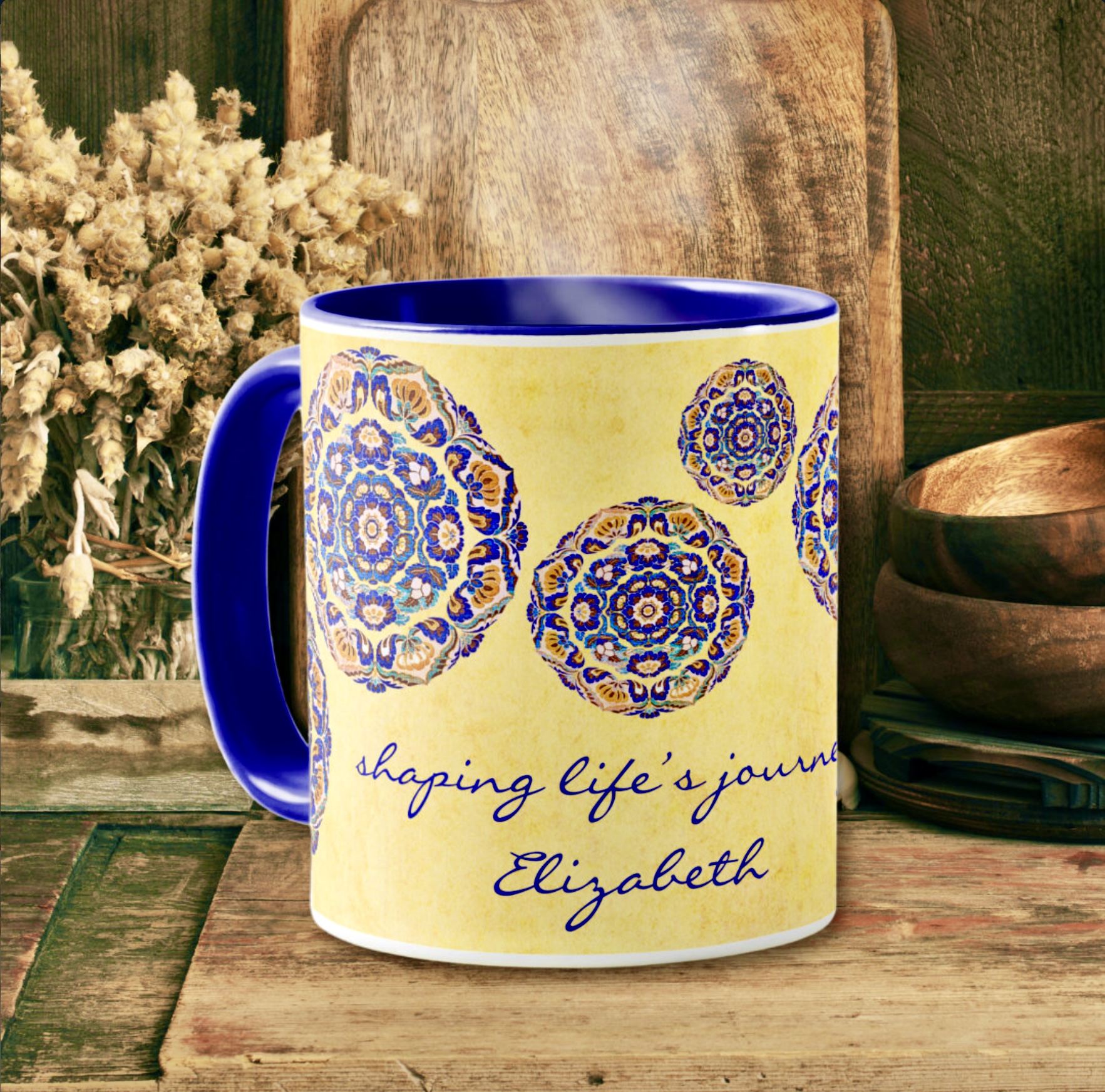 Coffee mug with blue medallion flowers on a yellow washed out surface design, and an inspirational message.