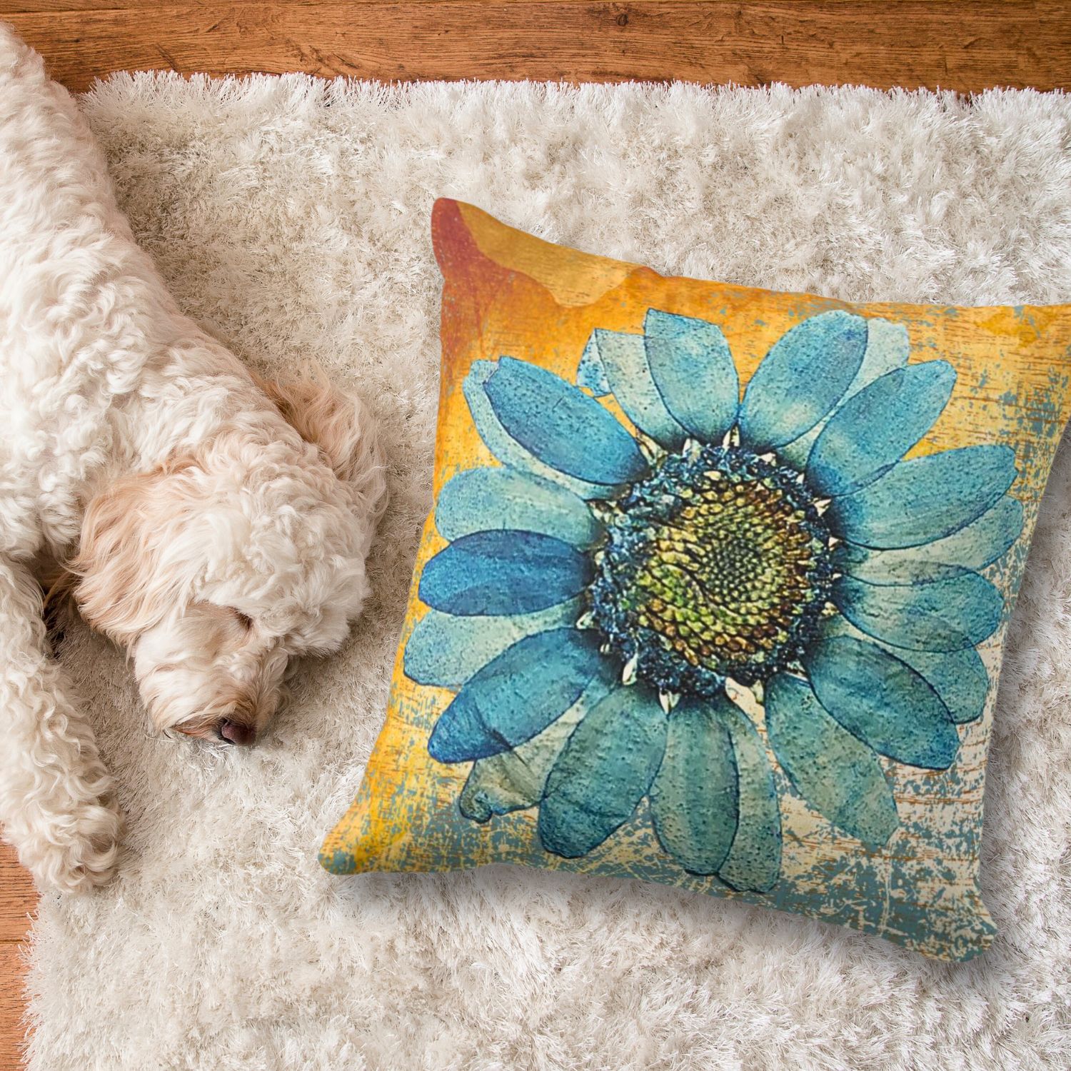 Large blue gerbera with orange washed out background on a white rug, and a dog sleeping on the side.