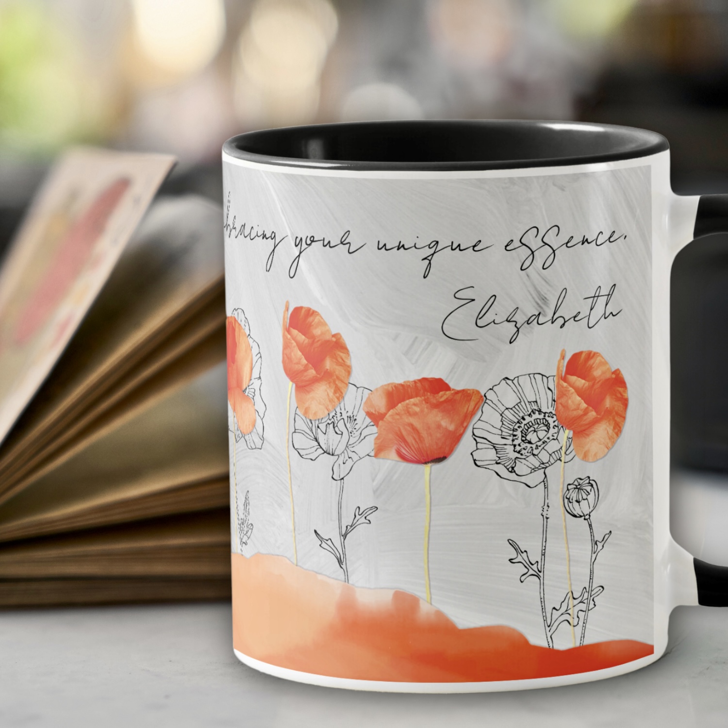 Gray coffee mug with bright orange poppy flowers and a black and white flower drawing on the background.
