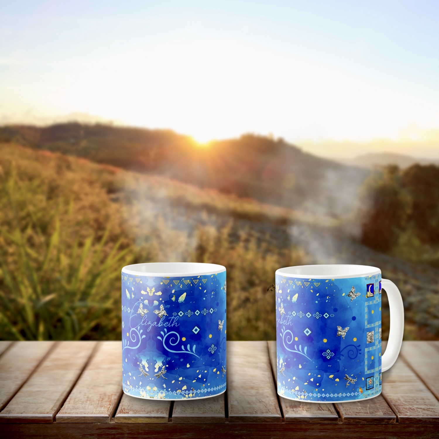 Two blue coffee mugs with Mexican tribal motifs in silver and light blue colors. 