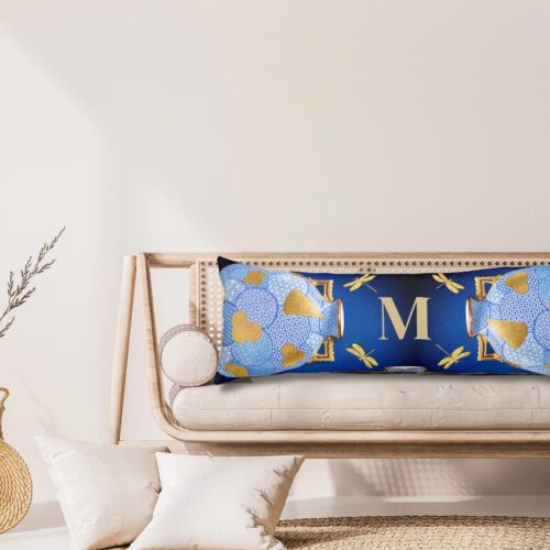 Unique luxury blue and gold body pillow, elegantly placed on an exquisite and simple chair in neutral colors.
