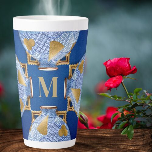 Invitingly presented, a unique luxury latte mug in elegant blue and gold hues rests amidst a simple yet exquisite setup adorned with vibrant red roses.