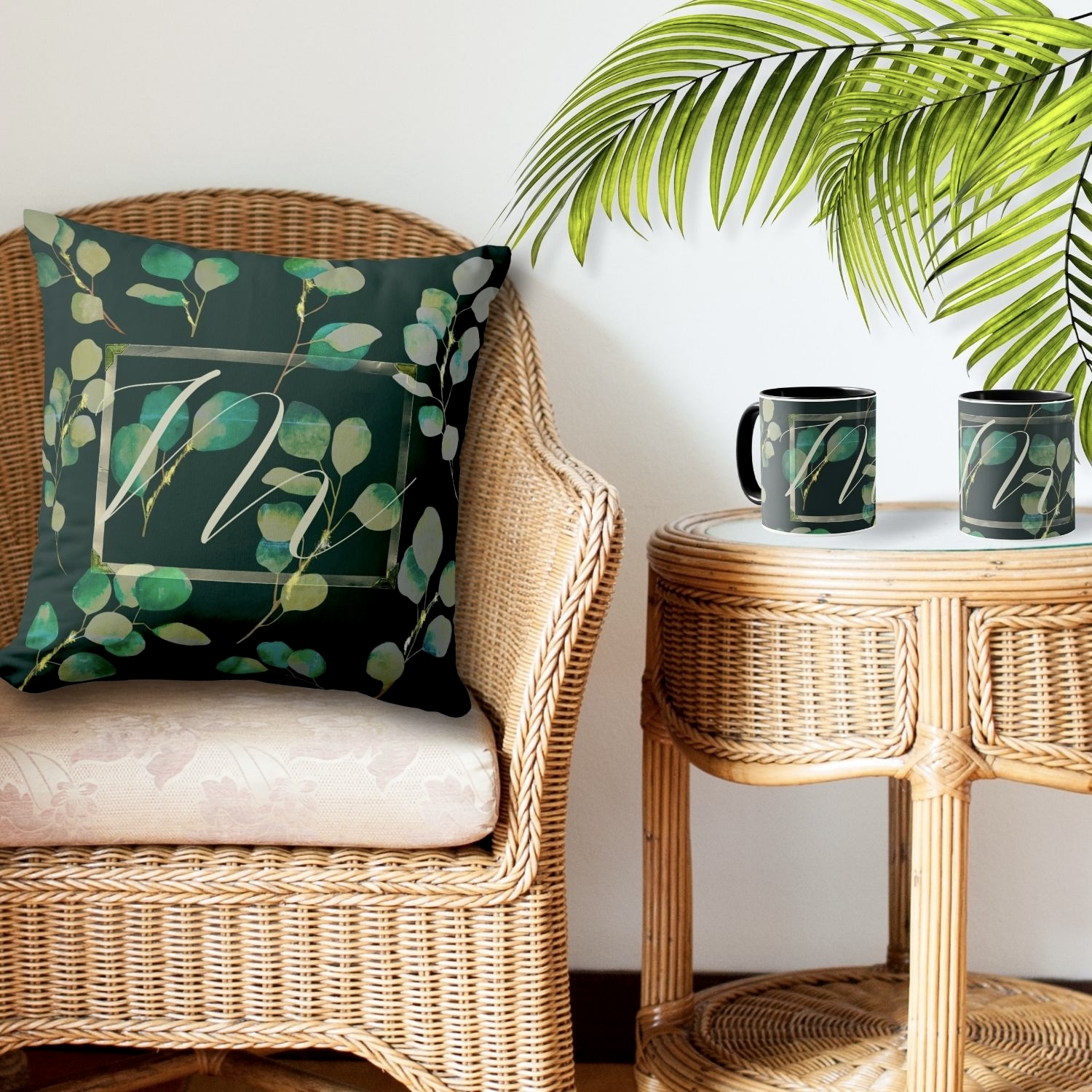 A monogrammed greenery accent pillow and mug featuring lush foliage patterns and personalized initials.