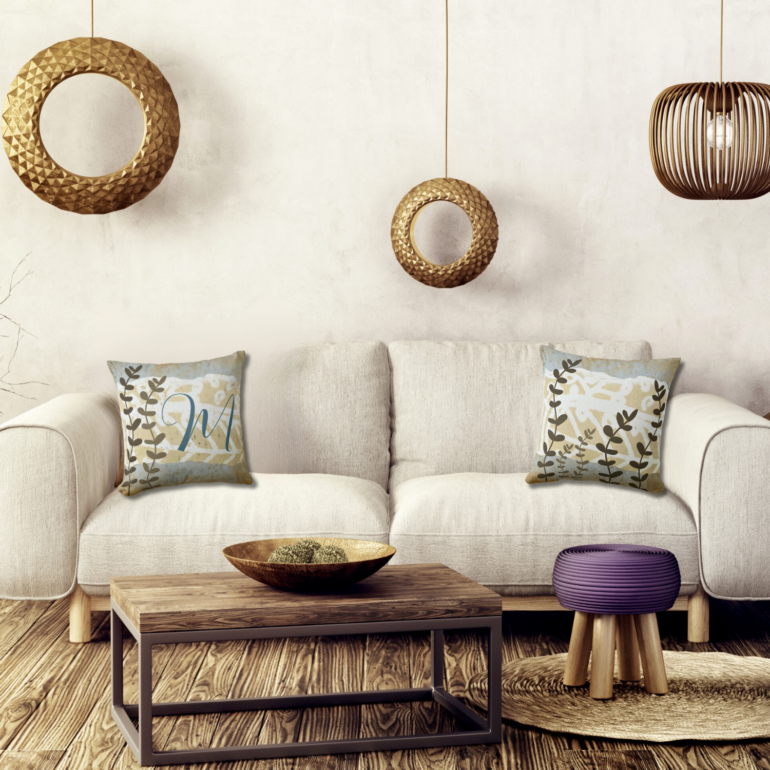 Boho living room with nature white sofa and two decorative monogram pillows in blue and browns.