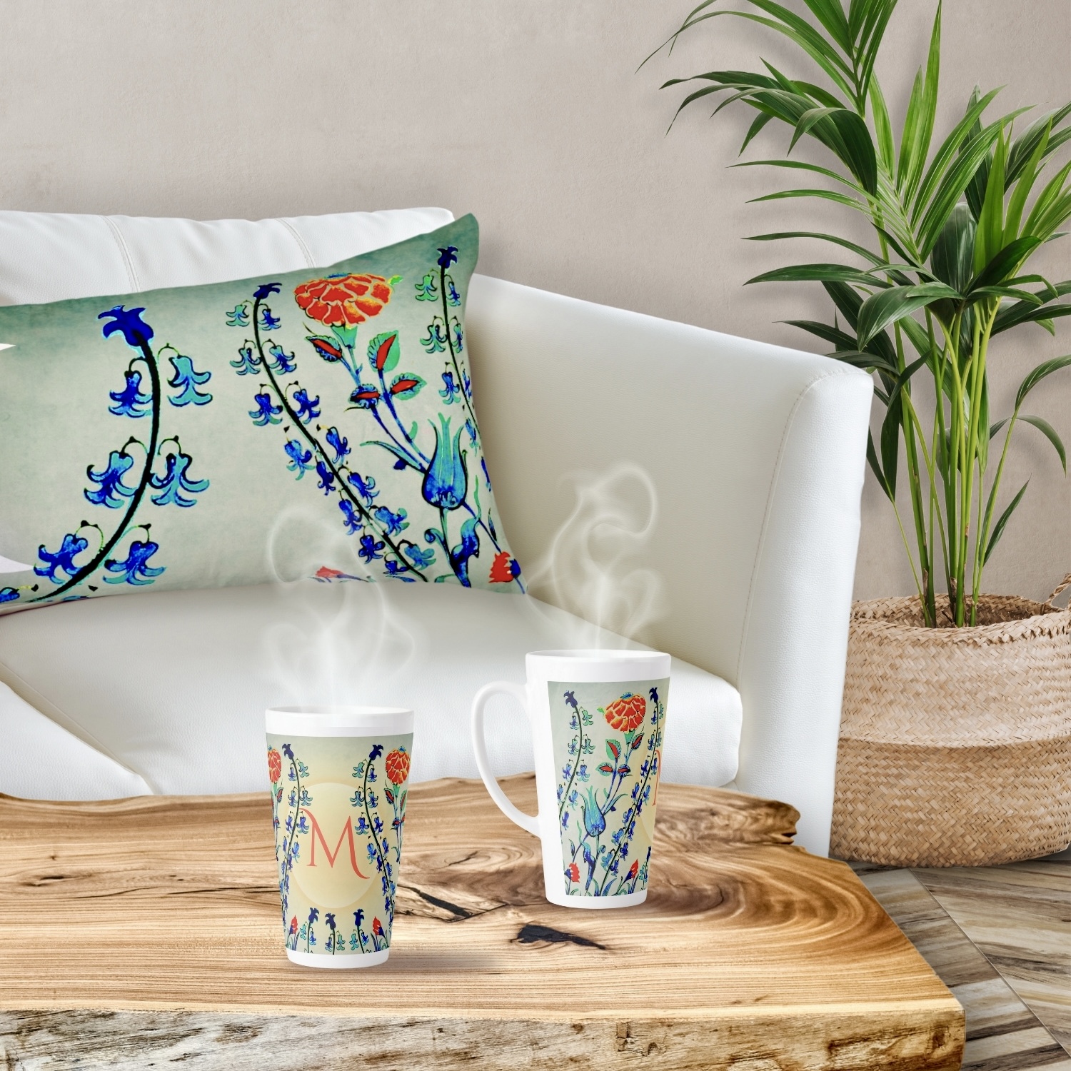 Vintage floral throw pillow with blue and bright orange flowers reminiscent of Ottoman Dynasty motifs, set against a sunset-like gradient background. Displayed alongside a matching mug adorned with a similar vintage floral design.