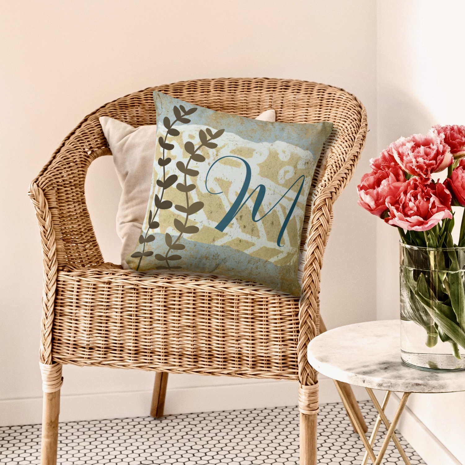 Monogram pillow boho style with earthy blue and brown colors.