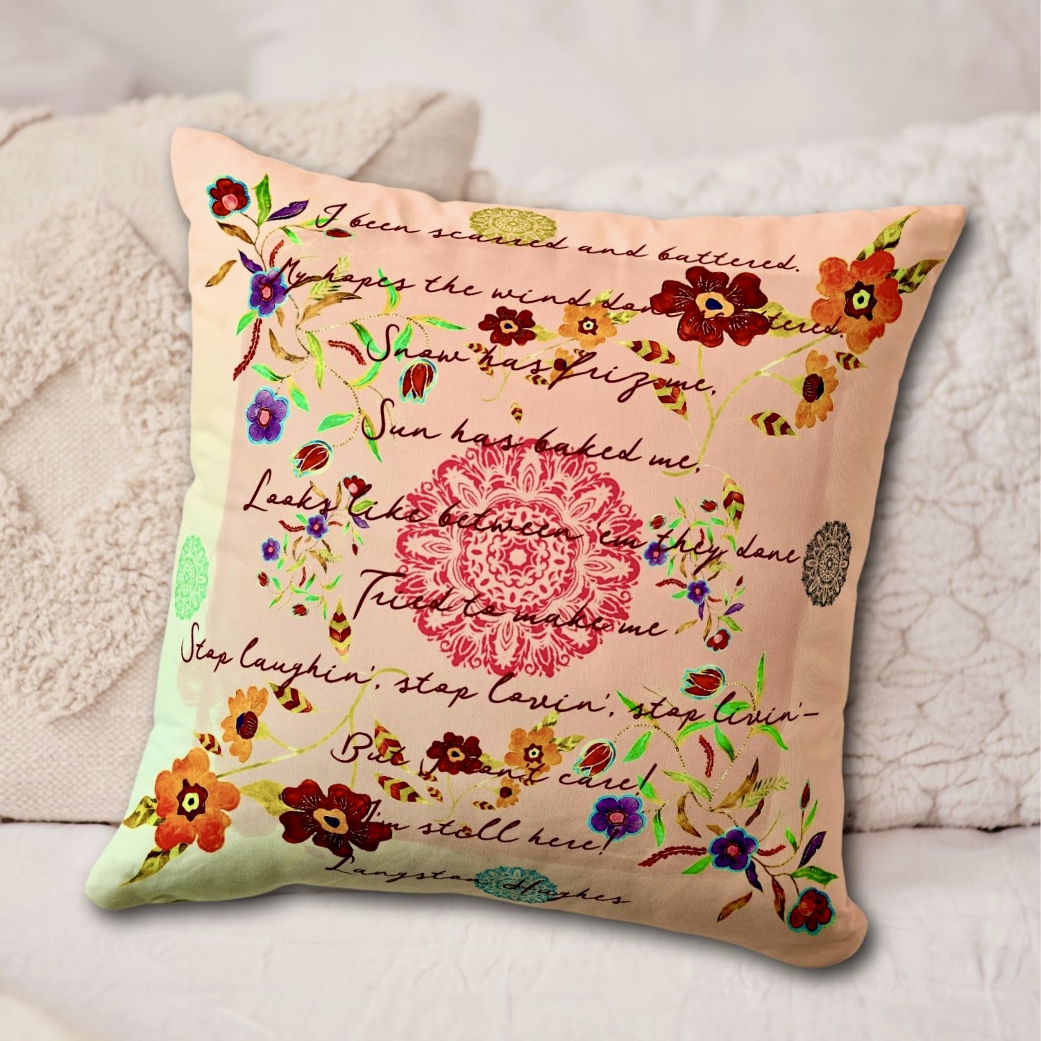 Decorative throw pillow adorned with intricate watercolor flower designs and a coral-toned mandala, featuring a portion of Langston Hughes' poem 'Still Here' for added literary inspiration.