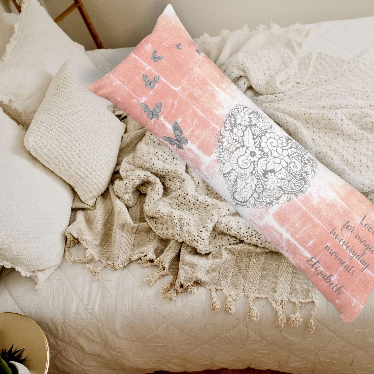 A body pillow resting on a boho beige bed, adding comfort and style to the bedroom decor.
