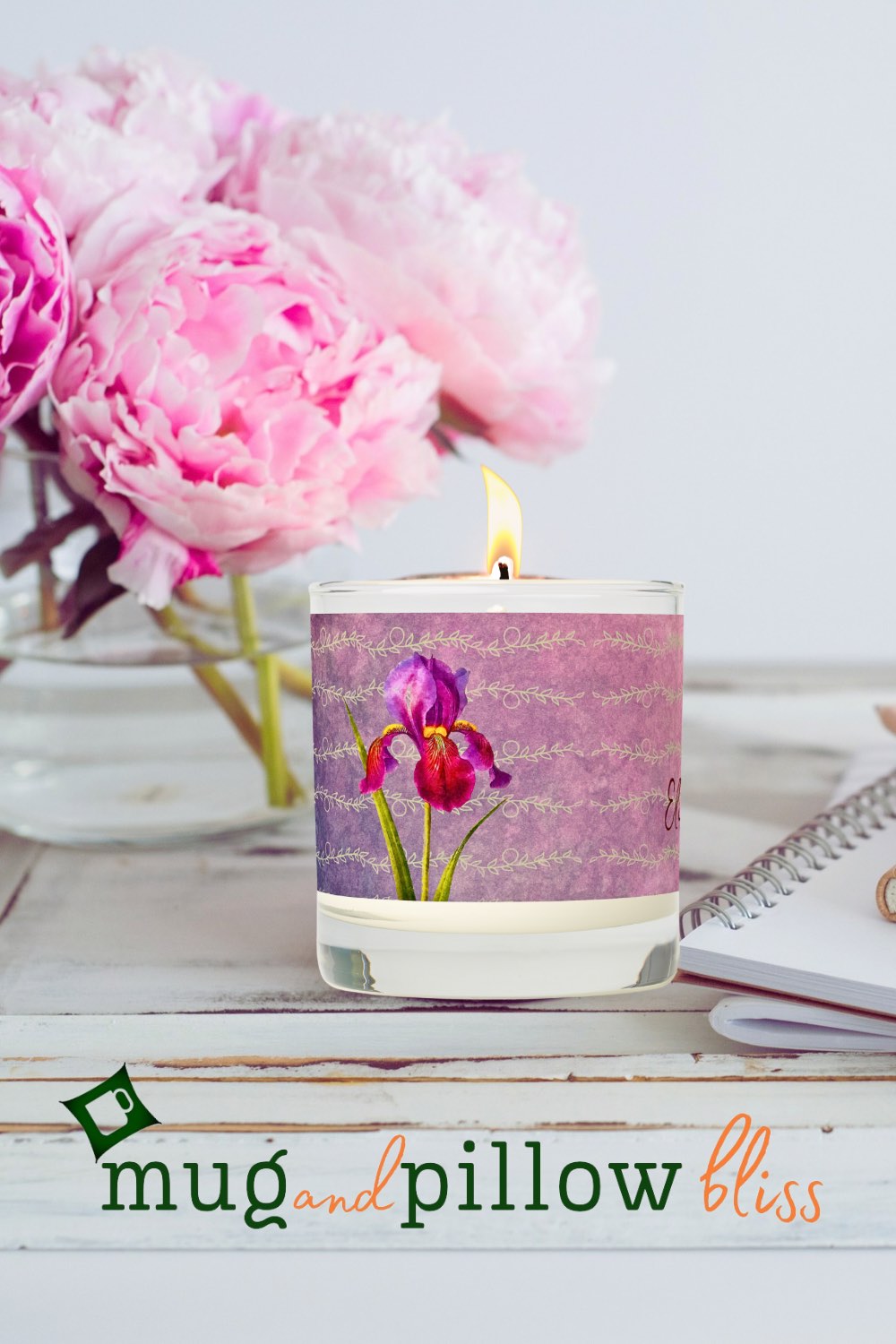 A scented candle with soft purple floral hues adding a touch of tranquility and relaxation to the snug room ambiance.