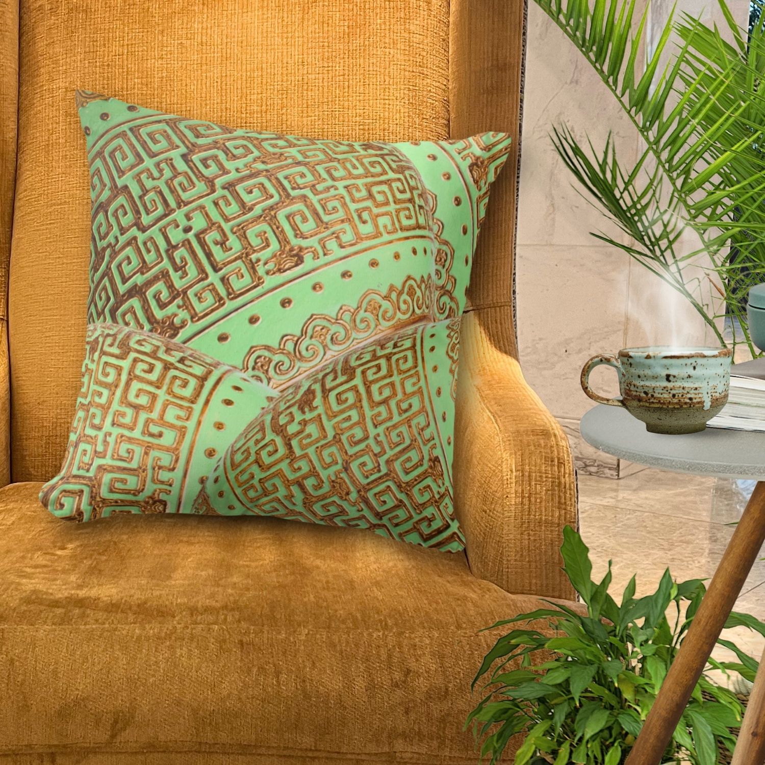 A vintage throw pillow with green mint and gold vintage patterns rests on a golden orange cozy chair. The intricate design of this mint and gold pillow adds elegance and charm to the vibrant seating arrangement, creating a striking visual contrast.