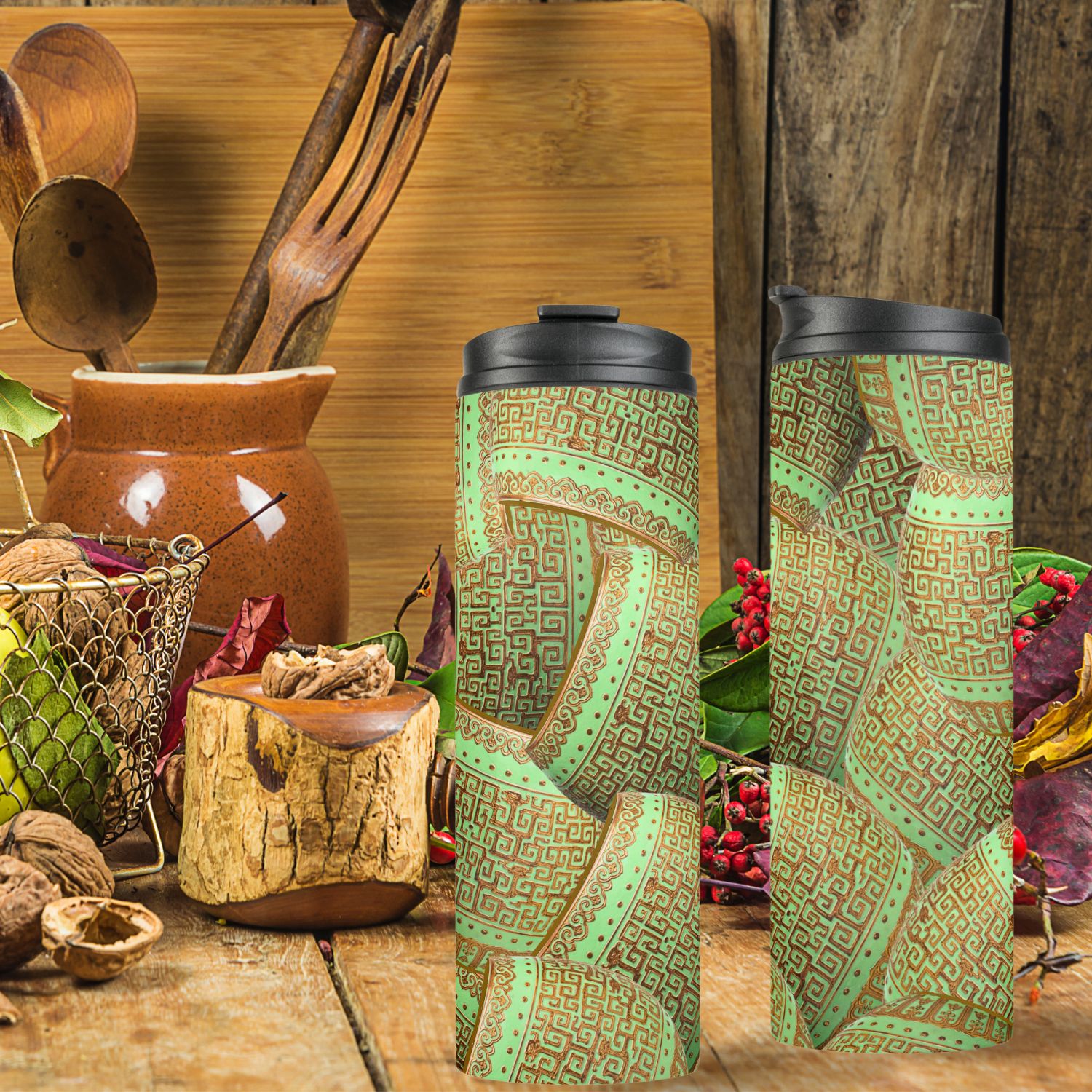 A thermal tumbler featuring intricate green mint and gold vintage patterns, in a rustic kitchen. Offering both style and practicality for enjoying hot or cold beverages on the go.