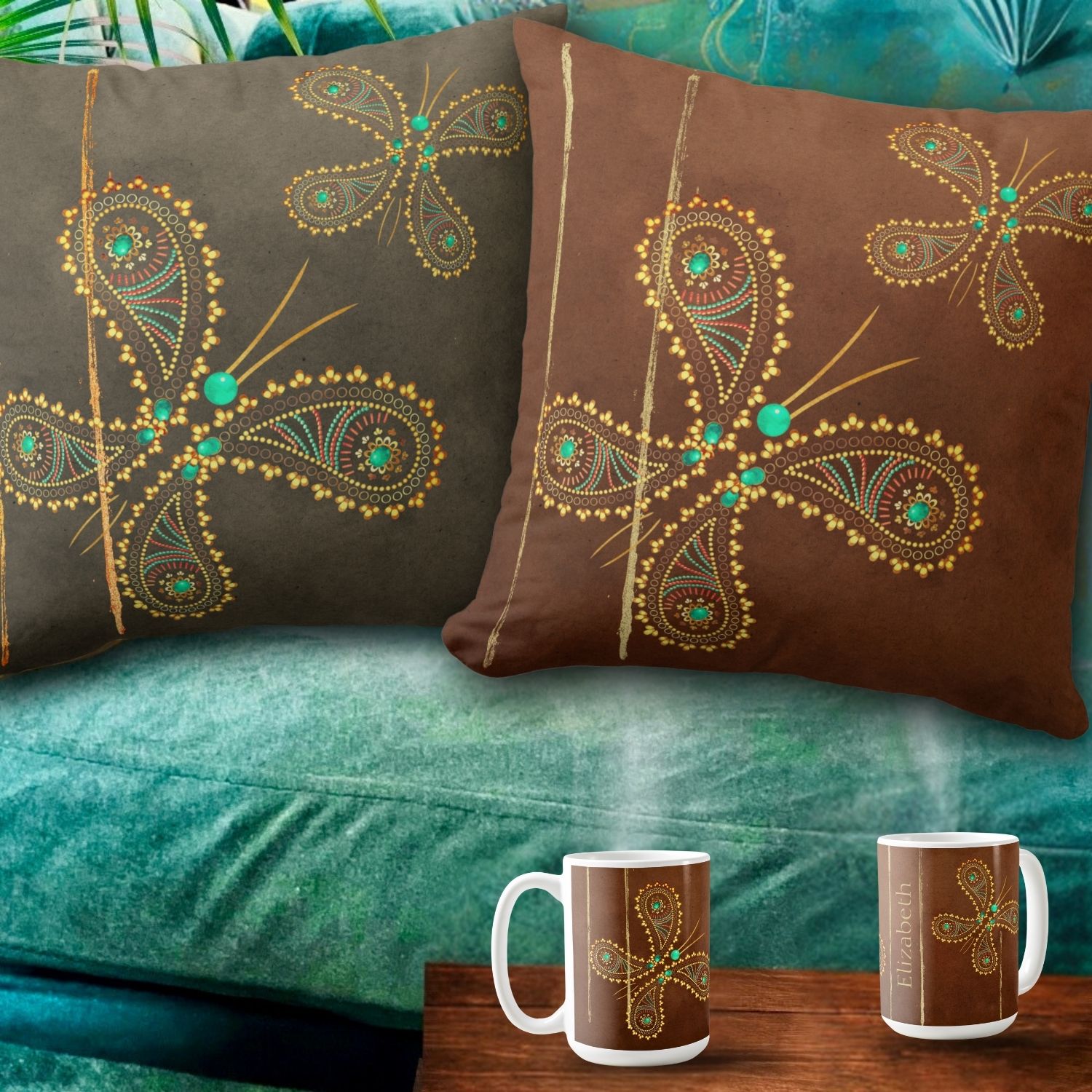 Two double-sided decorative throw pillows adorned with a teal and brown butterfly design, placed on a warm turquoise sofa. The intricate butterfly motifs in turquoise and golden hues stand out against the rich brown and light tan fabric colors of the pillows, adding a touch of whimsy and sophistication to the cozy ambiance of the space. Matching coffee mugs sit neatly underneath the pillows.