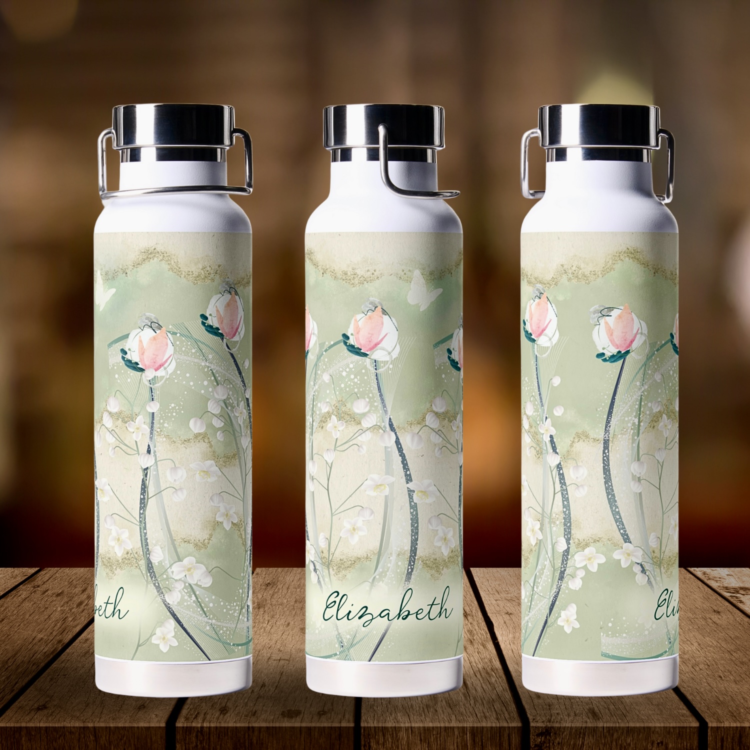 Custom moss green and white floral water bottle, with a three-sided design. The bottle features a pattern of delicate white flowers on a moss green background, accented with earthy beiges. The unique three-sided style creates a wrap-around effect, allowing the floral design to be visible from every angle. This water bottle includes a personalized element, where you can add a name or message, offering a customized touch to this bohemian-inspired item. Ideal for staying hydrated on the go.