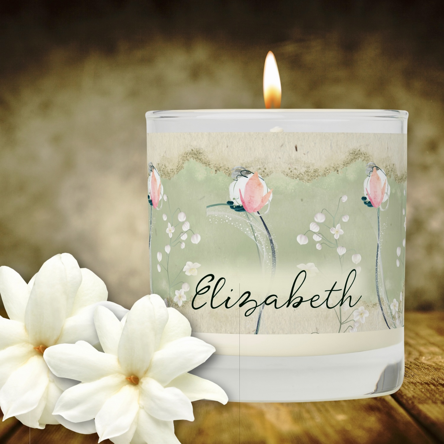 Scented candle featuring a bohemian-inspired design of delicate white flowers on a moss green background. The candle comes in a reusable jar with a lid, offering a practical and stylish way to fill your she shed space with a soothing fragrance. The floral pattern on the jar adds a touch of elegance and earthy charm, while the lid helps preserve the scent between uses. Ideal for creating a cozy ambiance in any room.