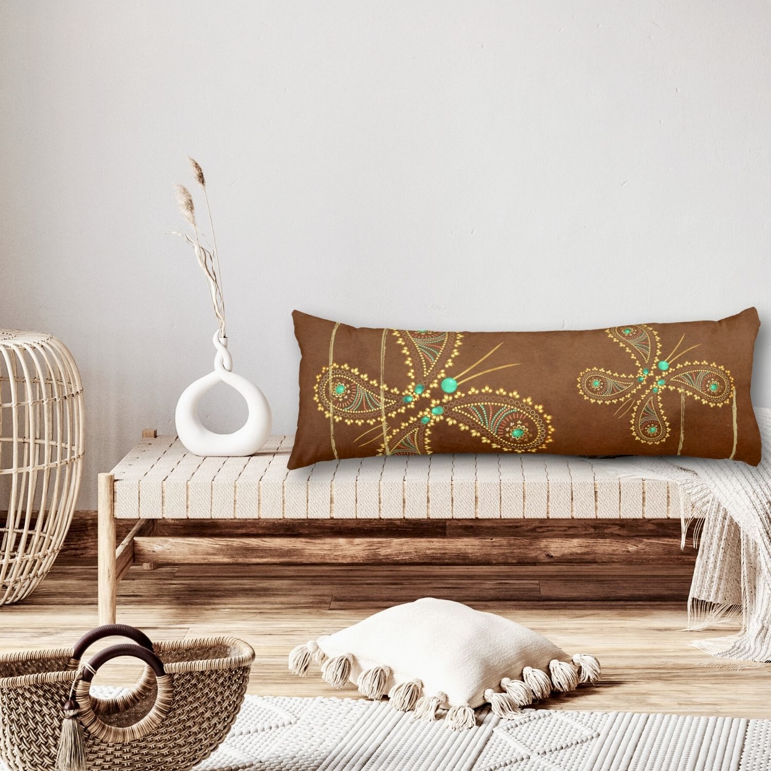 A close-up image showcasing a body pillow with a teal and brown butterfly design, placed on a boho-inspired neutral tones sitting area. The intricate butterfly motifs in turquoise and golden hues stand out against the textured fabric of the pillow, adding a touch of whimsy and sophistication to the cozy ambiance of the space.