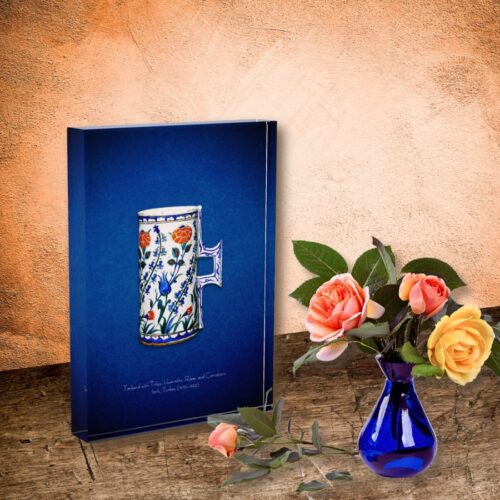 Acrylic block featuring a 16th-century Iznik floral tankard, a public domain masterpiece adorned with hyacinths, carnations, blue tulips, and red roses. The design showcases dynamic floral patterns influenced by Chinese blue-and-white porcelain, evolving into a unique style by the 1550s. The tankard, likely used as a vase for flowers, highlights the natural beauty and elegance of Ottoman art. The acrylic block provides stunning clarity and depth to the vibrant colors and intricate details.