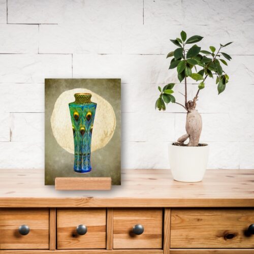 Public domain print on various surfaces: Featuring a vase filled with vibrant peacock feathers, displayed with a wooden holder. The detailed vase stands out against a subtle background, with feathers in shades of green and blue fanning out gracefully. Inspired by Japanese artist Kawade Shibataro, this artwork captures beauty, creativity, and tranquility. The wooden holder adds a natural, elegant touch to the presentation, enhancing the overall aesthetic.