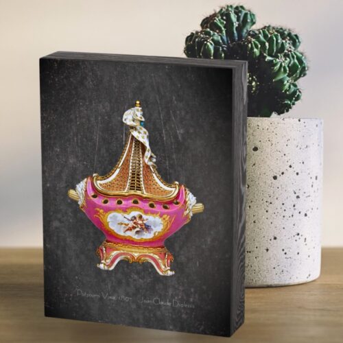 Wooden box print featuring the blush pink ship-shaped potpourri vase from the late 1750s Sèvres collection by Jean-Claude Duplessis, with a dark gray background and a rustic wooden frame. Public domain print on a wooden box.